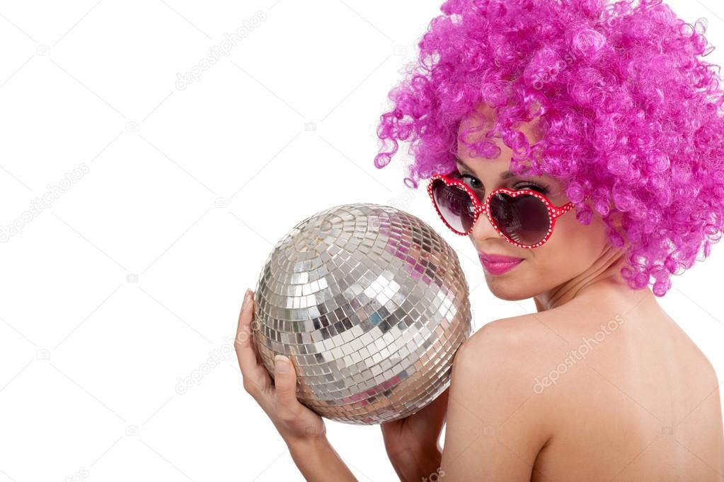 Beautiful young girl with pink wig holding  disco ball,isolated