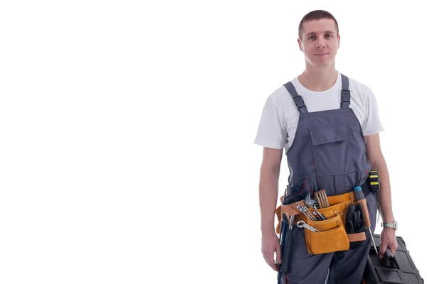 Joven trabajador con equipo caja de herramientas aislada en blanco — Foto de Stock