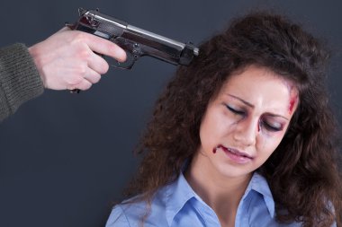 Terrorists holding a gun to a woman's head clipart