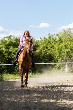 eğitim alanında onun kahverengi at binme genç gülümseyen kız