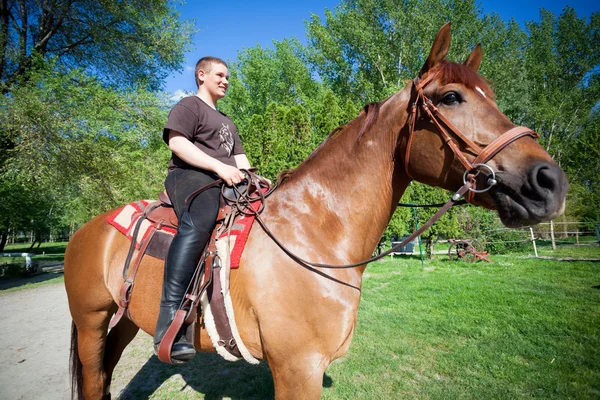Happy teenager boy on the horse — Stock Photo, Image