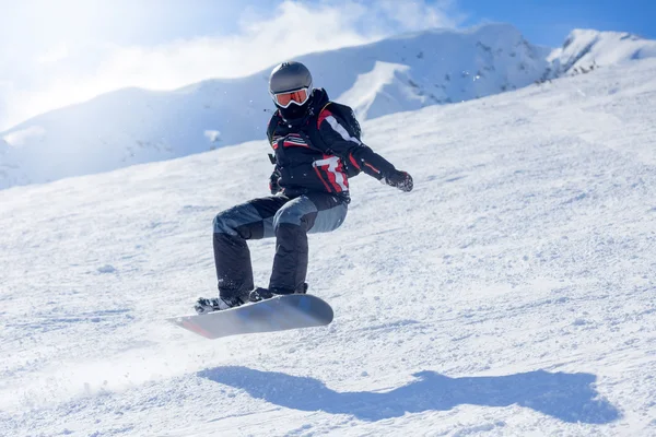 Snowboarder at jump inhigh mountains — Stock Photo, Image