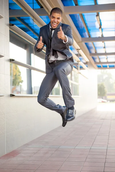 Businessman jumping, happy about the successful conclusion of a — Stock Photo, Image