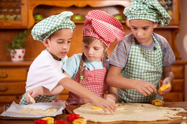 Two little chefs enjoying in the kitchen making big mess — Stock Photo, Image