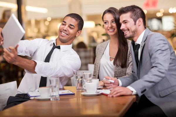 Business people taking selfie in restaurant — Stock Photo, Image