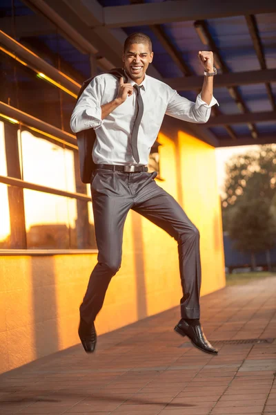 Businessman jumping, happy about the successful conclusion of a — Stock Photo, Image