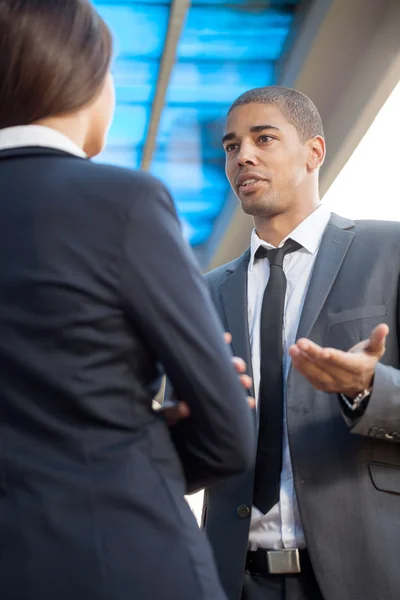 Businessman explaining colleague about work, outdoors — Stock Photo, Image
