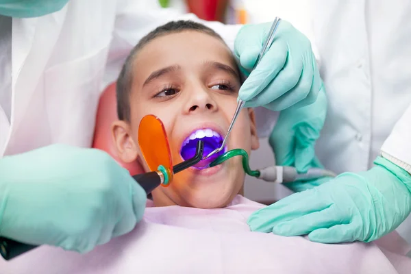 Close up de menino ter seus dentes examinados por um dentista — Fotografia de Stock