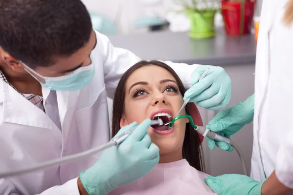 Dentist curing a girls teeth — Stock Photo, Image