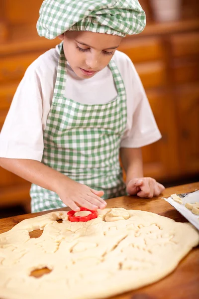 Ευτυχής χαμογελαστοί νεαρό αγόρι σεφ στην κουζίνα κάνοντας ζύμη — Φωτογραφία Αρχείου
