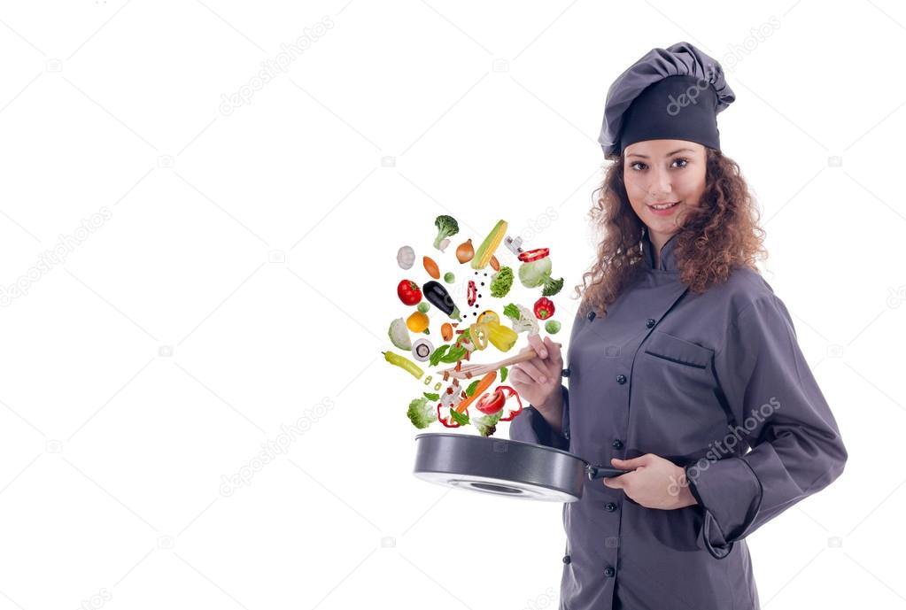professional woman chef throws food in the pan