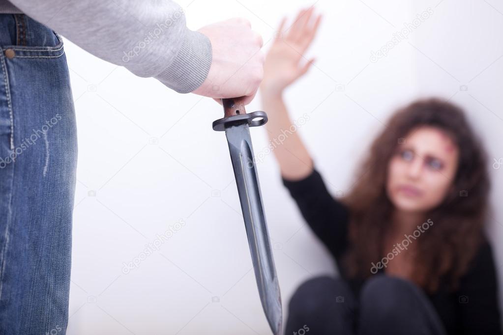 Husband holding a knife intimidates his wife