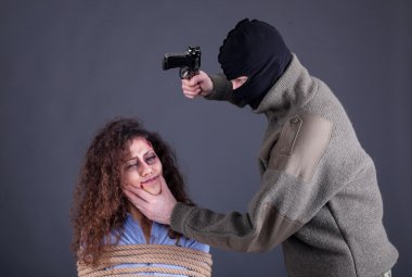 terrorists beating the a frightened girl with gun clipart