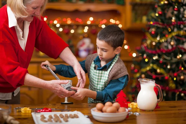 Nagymama és a kisfiú a konyhában készül a karácsony cookie-k — Stock Fotó