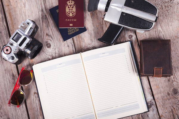 Preparation for travel, cell phone, passport,camera on wooden table