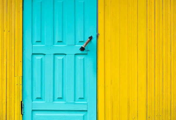 Painted wooden door on the wall background