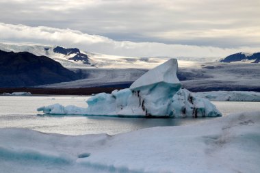 Melting glaciers climate change concept. Dramatic image of icebergs in Jokulsarlon lagoon at the evening. South Iceland.