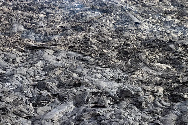 Texture of flowing lava. Volcano eruption at Fagradalsfjall, Iceland.  Volcanic background.