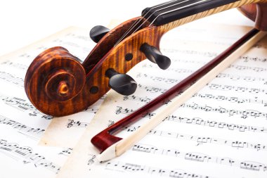 Close view of violin scroll and bow clipart