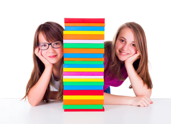 Two girls next to book column — Stock Photo, Image
