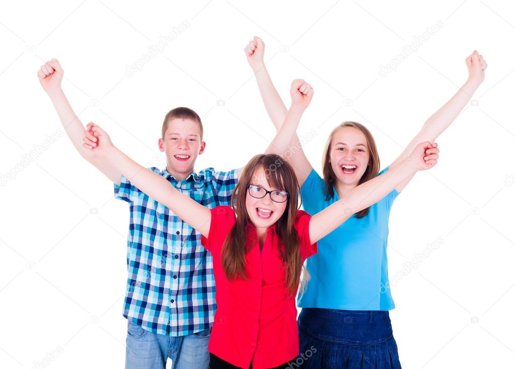 Group of happy teenagers raising hands