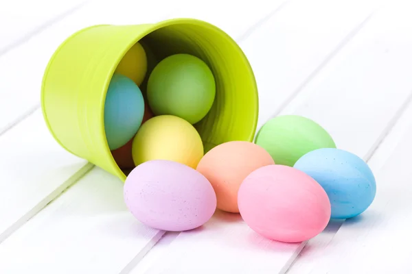 Easter eggs flowing out from bucket — Stock Photo, Image