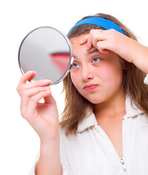 Girl examine her pimples in the mirror — Stock Photo, Image