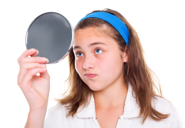 Girl examine her pimples in the mirror — Stock Photo, Image