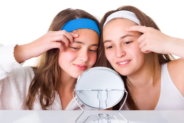 Girls searching for blemishes on theirs skin — Stock Photo, Image