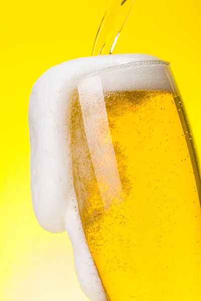 Macro of beer being pured into glass — Stock Photo, Image