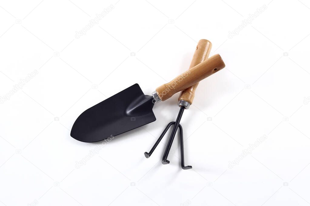 Tools garden shovel and rake isolated on white background