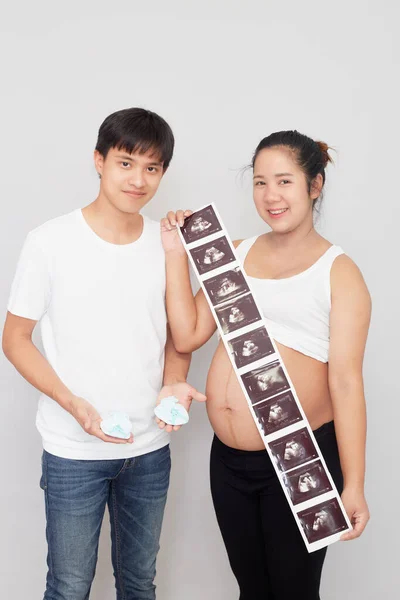 Asian lovely husband and wife portrait happy family expecting a baby  on white background