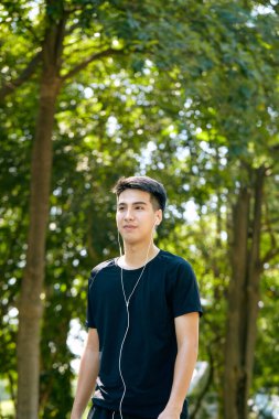 Genç Asyalı mutlu, güler yüzlü bir adam sabah dışarıda koşuyor. Fitness, spor, egzersiz ve egzersiz konsepti..