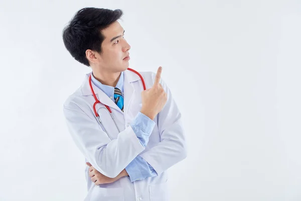 Asian Man Doctor Medical Gown Stethoscope Pointing Index Fingers Aside — Stock Photo, Image