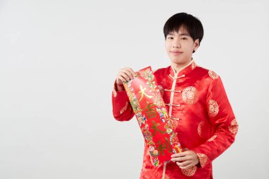 Geleneksel oryantal kostüm giymiş Asyalı bir adam Çin 'de yeni yıl kavramları için açık gri arka planda başarılı olmak adına Çince tebrikleri ve en iyi dileklerimi sunar.