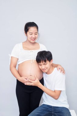 Interesting Asian couple, happy pregnant mother and father isolated on white background, International family day