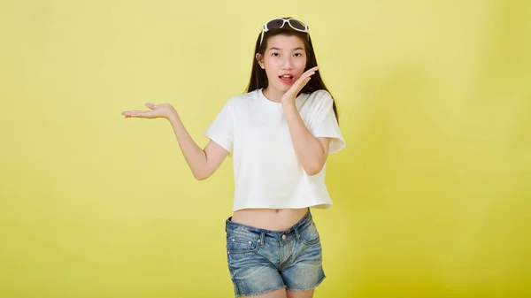 Young Beautiful Asian Woman Smiling Pointing Isolated Yellow Bright Color — Stock Photo, Image