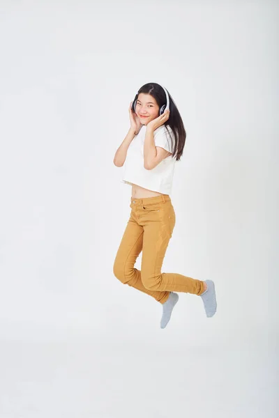 Jong Aziatisch Vrouw Met Hoofdtelefoon Springen Kleur Achtergrond — Stockfoto