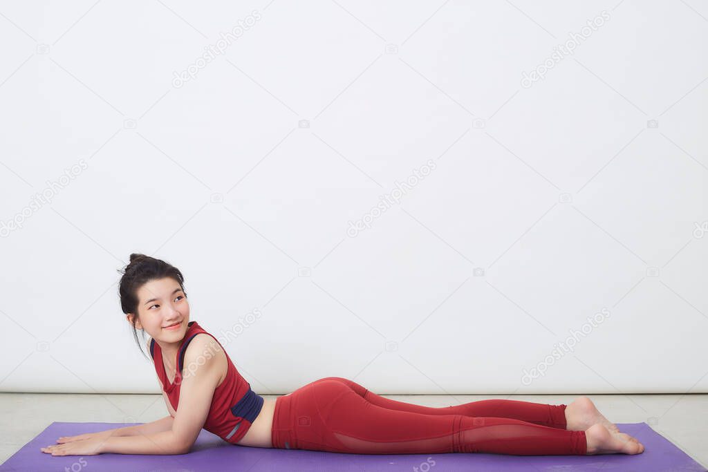 Young Asian woman exercise over light background