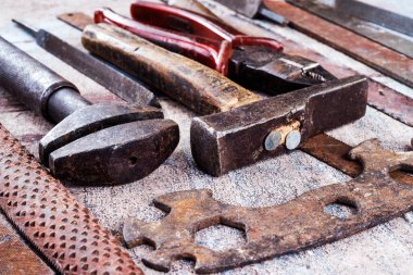 Ahşap arka planda paslı metal el aletleri