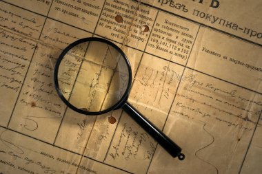 old deed property with magnifying glass