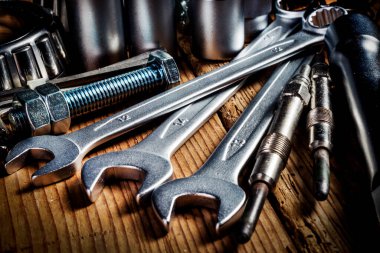 Ahşap arkaplanda araçlar ve eski otomobil parçaları