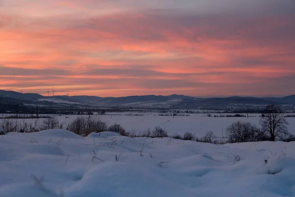 Winter sunset tops view from mountain village. Picturesque seasonal, nature and countryside beauty concept scene.