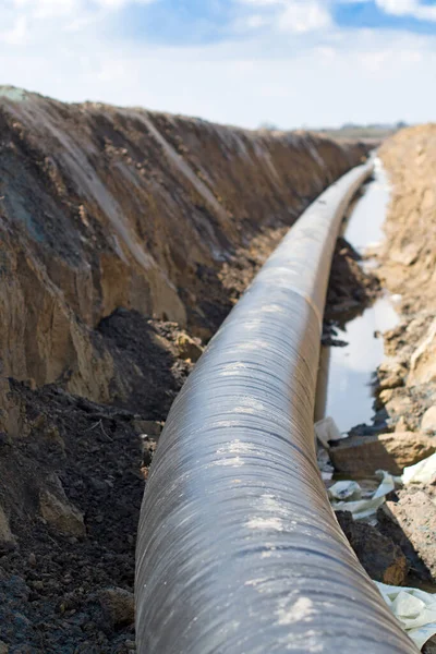 Natural gas pipeline construction work. A dug trench in the ground for the installation and installation of industrial gas and oil pipes. Underground work project