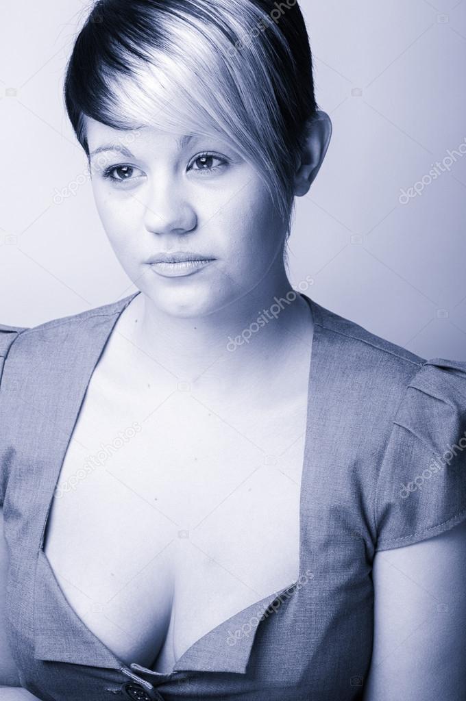 Cool blue toned  Shot of a Confident Young Office Woman . Plain 