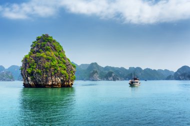 Ha Long Bay, Vietnam'da doğal karst isle ve turist teknesi