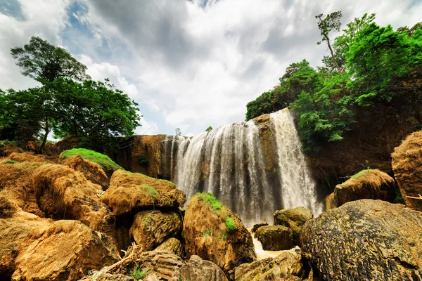 Bottom view of waterfall among green woods. Summer landscape — Stock Photo, Image