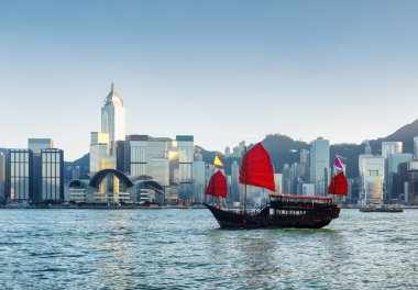 Traditional Chinese sailing ship in Victoria harbor at evening clipart