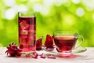 Magenta hibiscus tea (karkade, red sorrel) on nature background clipart