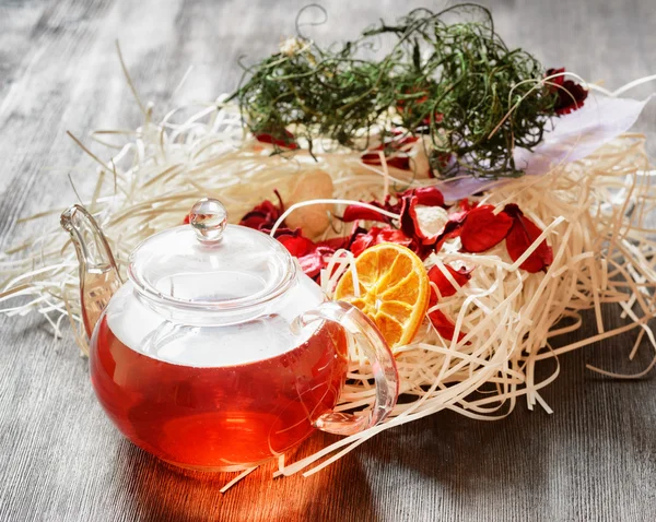 Glass pot of herbal tea — Stock Photo, Image